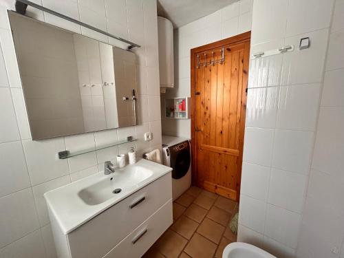 a bathroom with a sink and a toilet and a mirror at Casa Reija in Son Parc