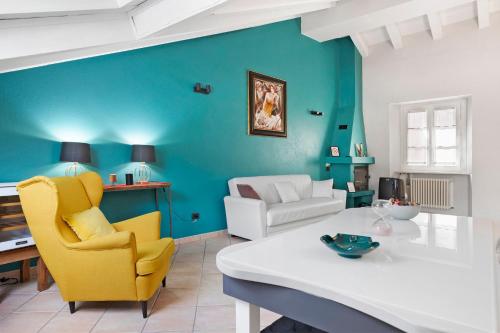 a living room with a white table and yellow chairs at Mema Holiday Home in Aosta