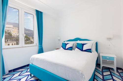 a bedroom with a bed and a window at Aurora Luxury Suites Seaview in Positano