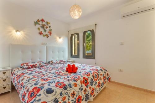 a bedroom with a bed with red shoes on it at Casa Alvates in Corralejo