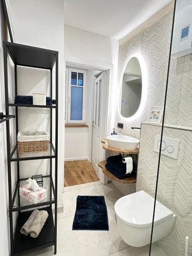 a bathroom with a toilet and a sink at Fewo Sand 10 - Altstadtsuite in Bamberg