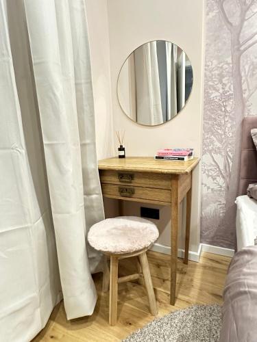 a dressing table with a stool and a mirror at Fewo Sand 10 - Altstadtsuite in Bamberg