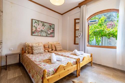 a bedroom with a bed and a window at House Theodora holidays Greece in Dragotiná