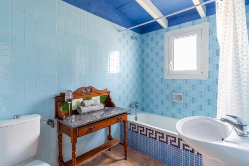 a bathroom with a sink and a toilet and a tub at Cala Serena Beach 5 in Felanitx