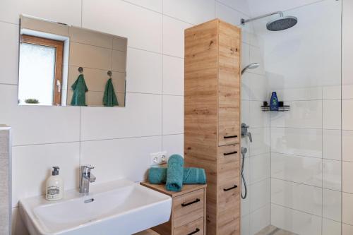 a white bathroom with a sink and a shower at Apart Elias in Gschnallenhof