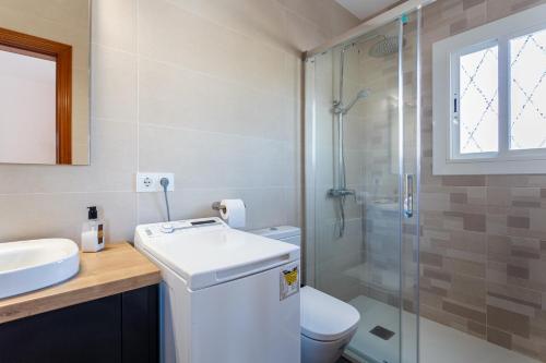 a bathroom with a toilet and a sink and a shower at Durero in Pineda de Mar