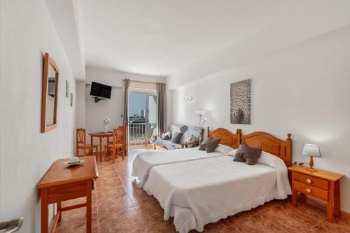 a bedroom with a bed and a living room at Apartamentos Martin - 22 in Puerto Naos