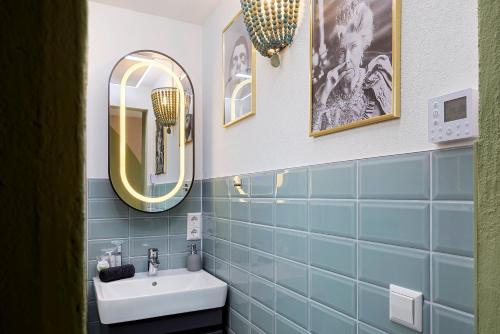 a bathroom with a sink and a mirror at Tiny House am Kaiserstuhl in Ihringen