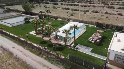 an aerial view of a house with a pool and palm trees at Villa Dehesa in Tabernas