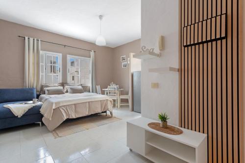 a bedroom with a bed and a blue couch at La Casa Bianco in El Cotillo