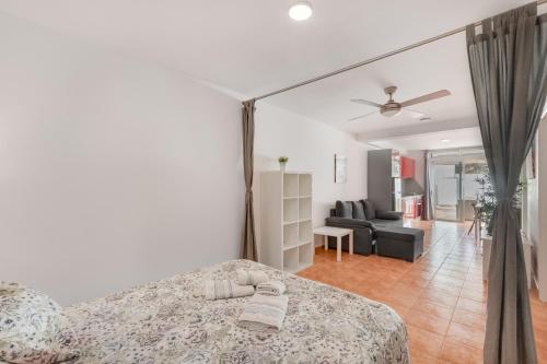 a bedroom with a bed and a living room at Vv Timón in Puerto de Mogán