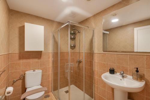 a bathroom with a toilet and a sink and a shower at Vv Timón in Puerto de Mogán