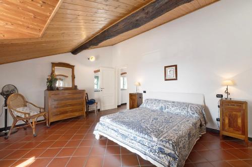 a bedroom with a bed and a wooden ceiling at Casa Marcone in Moneglia