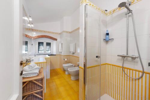 a bathroom with a shower and a toilet and a sink at Casa Marcone in Moneglia
