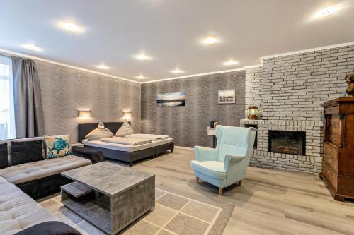 a living room with a couch and a fireplace at Studioapartment am Hafen in Flensburg