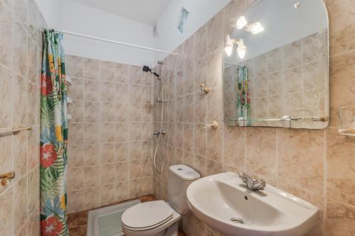 a bathroom with a sink and a toilet and a mirror at Apartamento Nayara B in Valle Gran Rey
