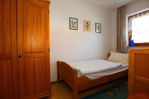 a small bedroom with a bed and a window at Haus Titisee in Löffingen