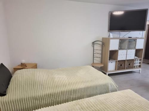 a room with two beds and a flat screen tv at Ferienwohnung Rheinnähe in Bad Säckingen