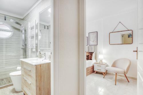 a white bathroom with a sink and a toilet at Verano Azul in La Mata