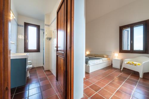 a room with a bed and a bathroom at Villa Ulivi 10 in Is Molas 
