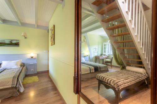 a bedroom with two beds and a stairway at Maison d'hôtes, Calme et Piscine in Habas