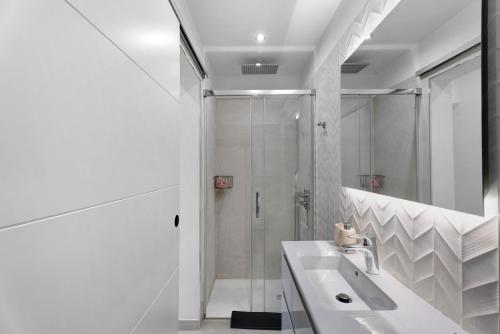 a white bathroom with a shower and a sink at Fantastic Villa Verano in San Miguel de Abona