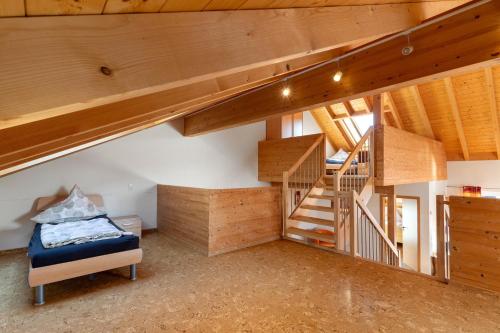 a room with stairs and a bed in a house at Obst- Und Ferienhof Brudy in Appenweier