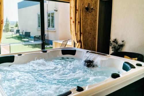 a bath tub with water coming out of it at Villa Montplaisir 180m² - Jacuzzi in Charmes-sur-Rhône