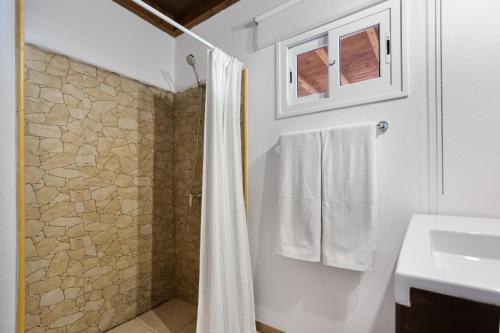 a bathroom with a shower curtain and a sink at Almar in Tinajo