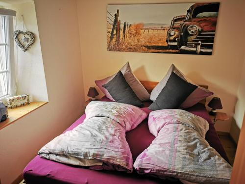 a bed with pillows on it in a bedroom at Haus Sonnenschein in Bad Bertrich