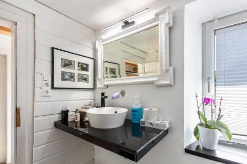 a bathroom with a sink and a mirror at Ferienwohnung auf dem Wald 6 Pers in Görwihl