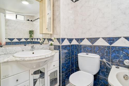 a bathroom with a toilet and a sink at Butterfly apartment in Nerja
