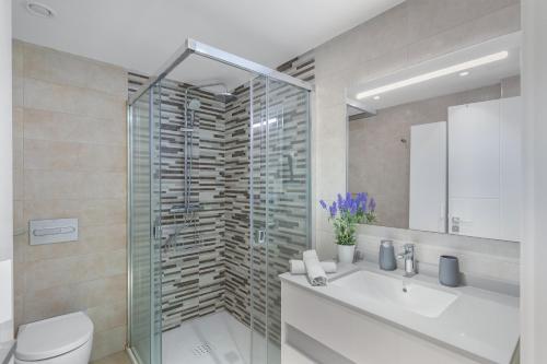 a bathroom with a shower and a toilet and a sink at Sunset Star Arguineguin in Arguineguín