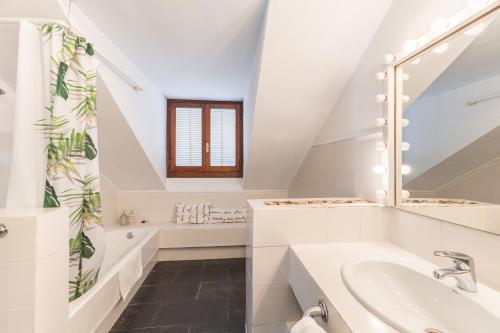 a white bathroom with a sink and a mirror at Casa Rural Cantueso 1 in La Matilla