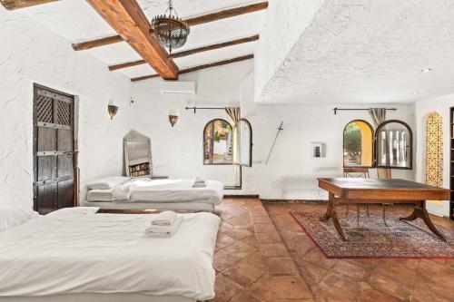 a room with three beds and a piano in it at Costa del Sol Retreat - 17 personas in Mijas