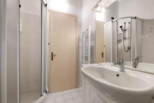 a white bathroom with a sink and a shower at Miralago Marone Holiday House in Marone