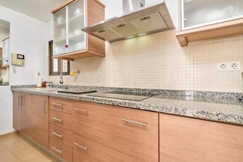 a kitchen with wooden cabinets and a counter top at El Nido in Almuñécar