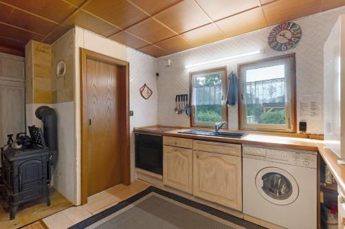 a kitchen with a washing machine and a stove at Haus am See in Gedern