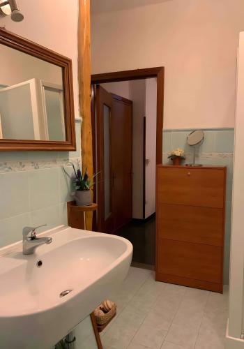 a bathroom with a white sink and a mirror at La Terrazza di Vernazza in Vernazza