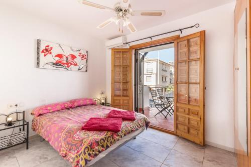 a bedroom with a bed and a door to a balcony at 53 Luz Bahia in Mazarrón