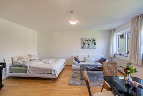 a living room with a couch and a table at Appartment Piano in Deisenhofen