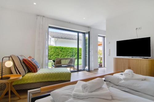 a living room with two beds and a television at Meili's Haus in Uhldingen-Mühlhofen