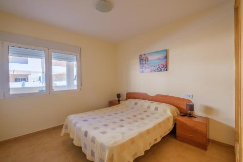 a bedroom with a bed and a window at Playasol in Vinarós