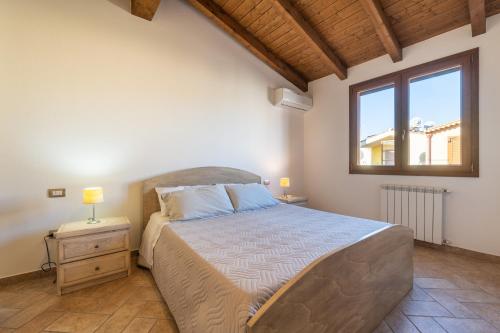 a bedroom with a large bed and a window at Girasole 2 in Pula