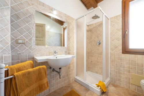 a bathroom with a sink and a shower at Girasole 2 in Pula