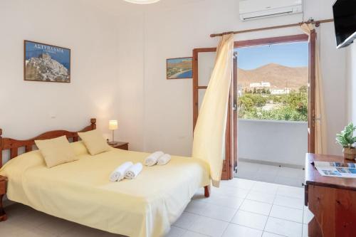 a bedroom with a bed with two towels on it at Studios Asterias 2 in Astypalaia