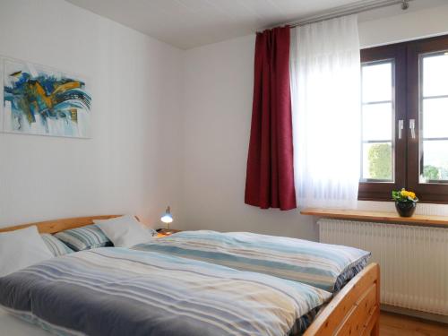a bedroom with a bed and a window at Ferienwohnung Ketterer in Breitnau