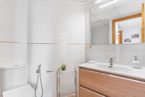 a white bathroom with a sink and a shower at Topete Alicante in Alicante