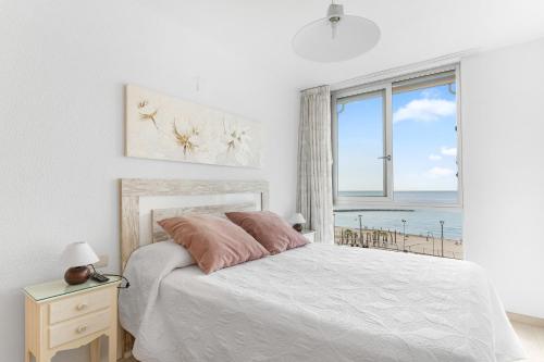 a bedroom with a bed with a view of the ocean at Topete Alicante in Alicante