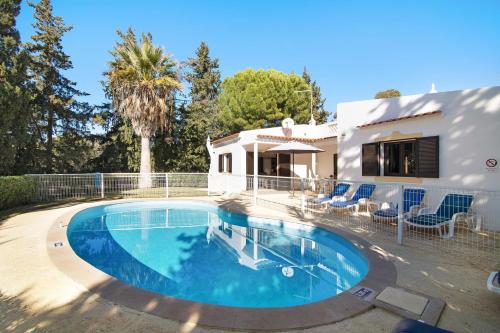 a swimming pool in front of a house at Vila Filipa in Guia